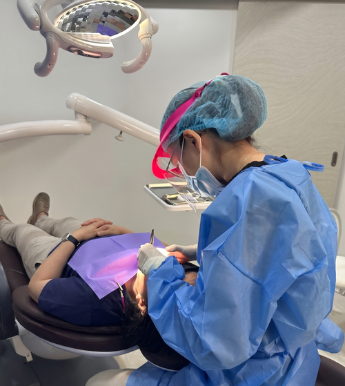 Dr Jamie Wong performing dental surgery